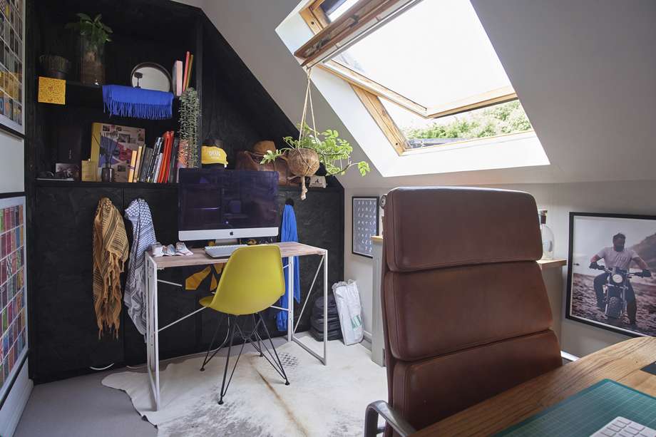 The vaulted studio office with desk and skylight